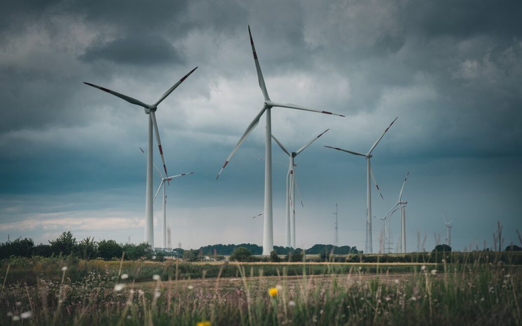 a-photo-of-massive-wind-turbines-in-a-fi_yxm-ByZ1Sp6SZJIVnn586w_RQwYTAtfTO2G4PcjWiSE0w
